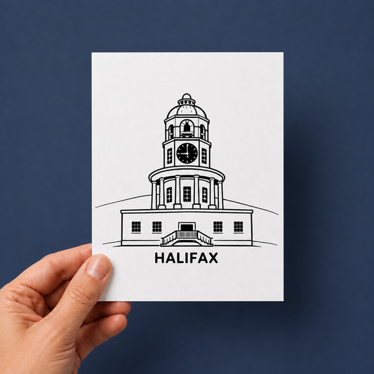 A hand holds a white art print featuring a black line drawing of the Halifax clock tower with the word 'HALIFAX' underneath, set against a dark blue background.